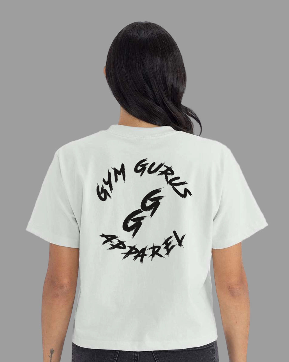 Person wearing a light green t-shirt with 'Gym Gurus Apparel' text on the back.