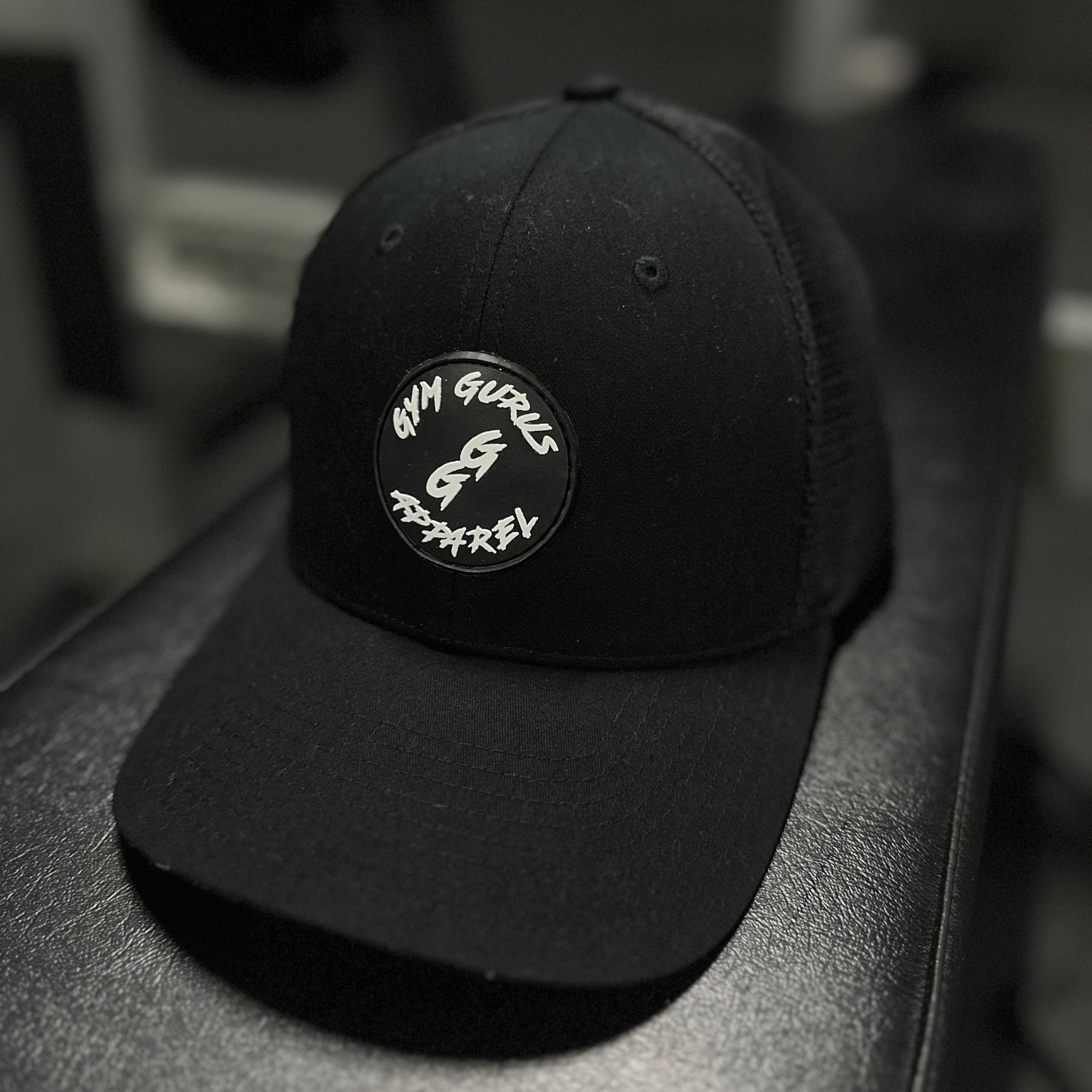 Black cap with a logo on a blurred background
